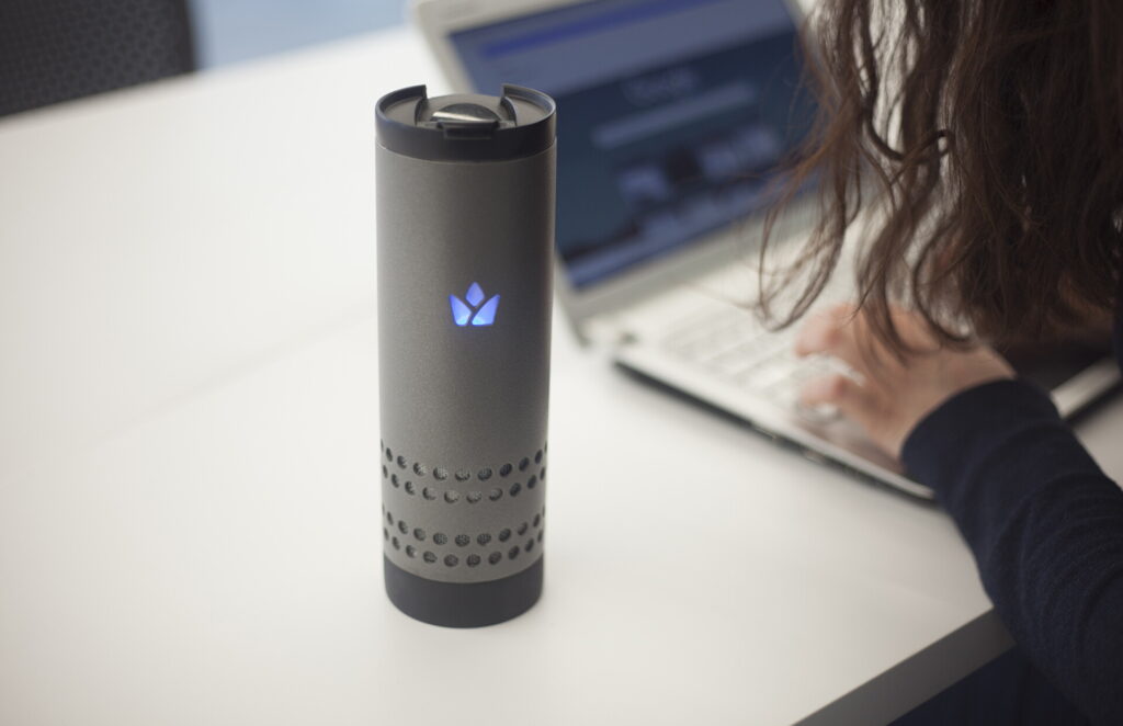 Yecup 365 smart mug beside a laptop